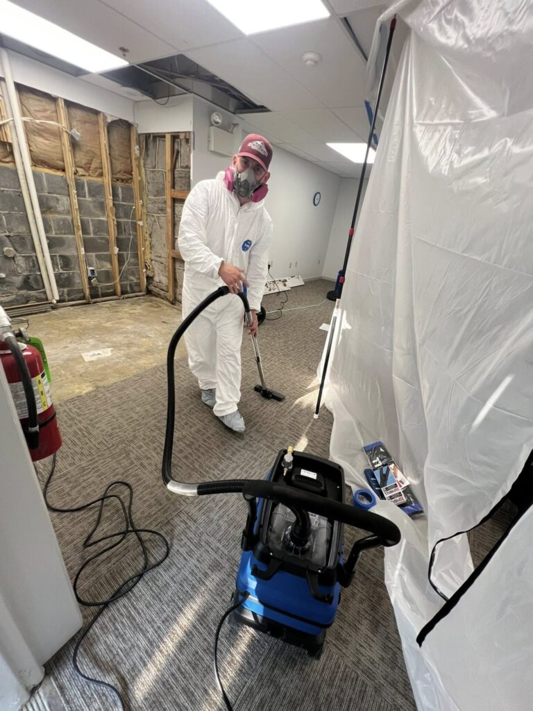 Water damage restoration technician removing water from LA home