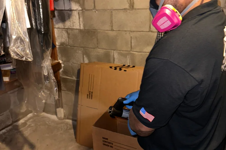 Technician assessing water damage in a Long Beach crawl space