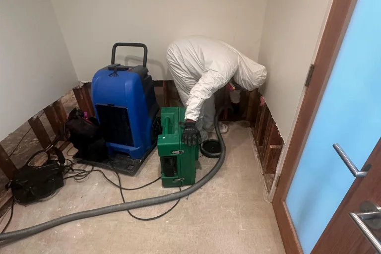 Dehumidifier drying an opened wall in a Long Beach property